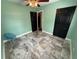 Green bedroom with a ceiling fan, black closet, and marble floors at 7709 Ravenna Ave, Orlando, FL 32819