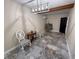 Dining room with marble floors, modern light fixture, and door to another room at 7709 Ravenna Ave, Orlando, FL 32819