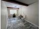 Dining room featuring marble floors, an exposed beam ceiling, and natural light at 7709 Ravenna Ave, Orlando, FL 32819