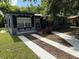Charming home with landscaped yard, gray paint and dark shutters, offering curb appeal at 7709 Ravenna Ave, Orlando, FL 32819