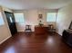 Inviting living room featuring hardwood floors and a dark front door at 7709 Ravenna Ave, Orlando, FL 32819