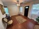 Inviting living room featuring hardwood floors, elegant furnishings and a dark front door at 7709 Ravenna Ave, Orlando, FL 32819
