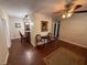 Inviting living room featuring hardwood floors, elegant furnishings and view to kitchen at 7709 Ravenna Ave, Orlando, FL 32819