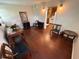 Living room with hardwood floors leading into kitchen with white appliances at 7709 Ravenna Ave, Orlando, FL 32819