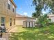 Backyard view with a shed, green grass, and partial view of the home at 7939 Riffle Ln, Orlando, FL 32818