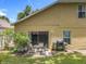 This backyard features a table with chairs, a grill, and a sliding glass door at 7939 Riffle Ln, Orlando, FL 32818