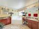 Bathroom featuring a jacuzzi tub, granite countertops, two sinks, and a window at 7939 Riffle Ln, Orlando, FL 32818