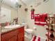 Cozy bathroom featuring elegant vanity with granite counter, framed mirror, and decorative accents at 7939 Riffle Ln, Orlando, FL 32818