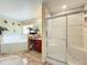 Featuring a shower, jacuzzi tub, granite countertops, and beautiful tile floors at 7939 Riffle Ln, Orlando, FL 32818