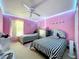 Cozy bedroom featuring two twin beds, and a large window bringing in natural light at 7939 Riffle Ln, Orlando, FL 32818