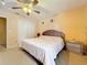 This bedroom features a ceiling fan, a nightstand, a closet, and a bed with a white comforter at 7939 Riffle Ln, Orlando, FL 32818