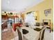 Bright kitchen with granite counters, stainless appliances, island and adjacent dining area with seating at 7939 Riffle Ln, Orlando, FL 32818