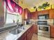 Modern kitchen with stainless steel appliances and granite countertops at 7939 Riffle Ln, Orlando, FL 32818
