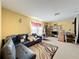 This living room features a couch, a rug, a window, a TV, and a desk at 7939 Riffle Ln, Orlando, FL 32818