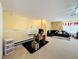 This living room features an office desk, a couch, a window, and a TV at 7939 Riffle Ln, Orlando, FL 32818