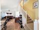Open concept dining and living room with staircase at 7939 Riffle Ln, Orlando, FL 32818