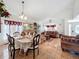 Open concept dining and living room with tile flooring and large windows at 7939 Riffle Ln, Orlando, FL 32818