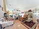 Open-concept living room and dining area featuring tile floors and elegant decor at 7939 Riffle Ln, Orlando, FL 32818