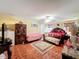 Large primary bedroom with a ceiling fan, area rug, and walk-in closet at 7939 Riffle Ln, Orlando, FL 32818