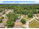 Aerial view of the neighborhood showing homes nestled among mature trees at 7939 Riffle Ln, Orlando, FL 32818