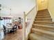 View of staircase leading to the upper level with open floorplan and adjacent dining room at 7939 Riffle Ln, Orlando, FL 32818