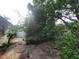 A view of the backyard with some plants and bushes with red stepping stones at 8603 Snowfire Dr, Orlando, FL 32818