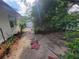 A view of the backyard with some plants and bushes with red stepping stones at 8603 Snowfire Dr, Orlando, FL 32818