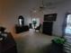 A dimly lit bedroom features furniture, carpet, a ceiling fan, and natural light at 8603 Snowfire Dr, Orlando, FL 32818