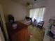 A quiet bedroom has neutral walls and is decorated with comfortable furniture and a ceiling fan at 8603 Snowfire Dr, Orlando, FL 32818