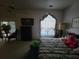 A dimly lit bedroom features furniture, carpet, a ceiling fan, and natural light at 8603 Snowfire Dr, Orlando, FL 32818