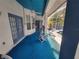 View of the carpeted patio area with ceiling fan, seating, and access to the screened-in pool area at 8603 Snowfire Dr, Orlando, FL 32818