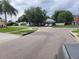 A view of a ranch style house from a corner street with two cars in the driveway at 8603 Snowfire Dr, Orlando, FL 32818