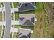 An aerial view shows a well-kept property with solar panels, a driveway, and a lush green lawn at 873 Daring Dr, Davenport, FL 33837