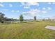 Lush backyard with a serene pond view, perfect for outdoor activities and relaxation at 873 Daring Dr, Davenport, FL 33837