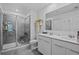 Bright bathroom features double sinks and a tiled shower with safety seat and convenient grab bar at 873 Daring Dr, Davenport, FL 33837