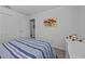 Cozy bedroom with striped bedding, closet, and a dresser; features a soft, welcoming atmosphere at 873 Daring Dr, Davenport, FL 33837