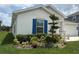 Landscaped front yard with blue shutters and well-maintained greenery at 873 Daring Dr, Davenport, FL 33837