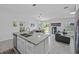 Open floor plan with a modern kitchen island, stainless steel appliances, and a view of the living area at 873 Daring Dr, Davenport, FL 33837