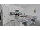 Modern kitchen with a center island, stainless steel appliances, and bright white cabinets at 873 Daring Dr, Davenport, FL 33837