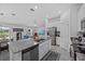 Open concept kitchen with stainless steel appliances, center island, and views into the living and dining areas at 873 Daring Dr, Davenport, FL 33837