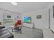Bright living room with tiled floor features a comfortable sofa, glass table, and modern media center at 873 Daring Dr, Davenport, FL 33837