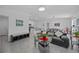 Open-concept living area featuring tile floors, modern furnishings, and a dining space at 873 Daring Dr, Davenport, FL 33837