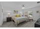 Bright main bedroom showcases a comfortable bed, soft carpet, and a sunlit window with views of nature at 873 Daring Dr, Davenport, FL 33837
