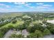 Breathtaking aerial shot capturing golf course and residential homes surrounded by lush green vegetation and lakes at 8932 Village Green Blvd, Clermont, FL 34711