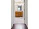 Hallway view of bathroom featuring tile floors and wooden cabinets at 8932 Village Green Blvd, Clermont, FL 34711