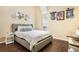 Cozy bedroom featuring hardwood floors, a full sized bed, and decorative mirrors at 8932 Village Green Blvd, Clermont, FL 34711