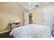 Bright bedroom showcasing neutral walls, wood floors, and an open doorway at 8932 Village Green Blvd, Clermont, FL 34711