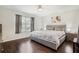 Bedroom featuring hardwood floors, a window, and a gray upholstered bed frame at 8932 Village Green Blvd, Clermont, FL 34711