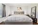 Well-lit bedroom with light gray walls and hardwood floors at 8932 Village Green Blvd, Clermont, FL 34711