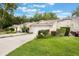 Charming single-story home featuring a well-maintained lawn, attached garage, and inviting curb appeal at 8932 Village Green Blvd, Clermont, FL 34711